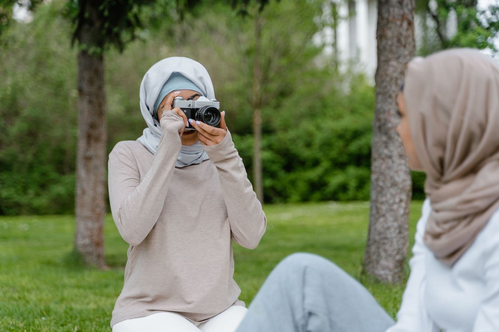 Stock photograph of two friends taking photos outdoors, by MART PRODUCTION